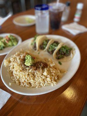 Street tacos with cilantro in Mexican rice