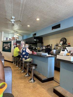 Bar area with the best waitress serving up some good coffee .