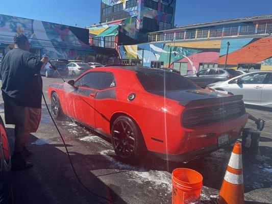 Big Mike, the owner, with a detailed wash deluxe on this red beauty!