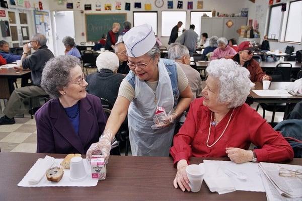 Volunteer serving lunch at one of our Community Nutrition sites in San Francisco.