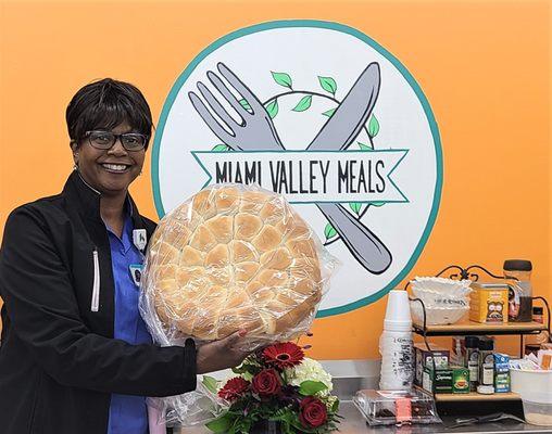 Baker preparing to deliver meals and dinner rolls to families in need.