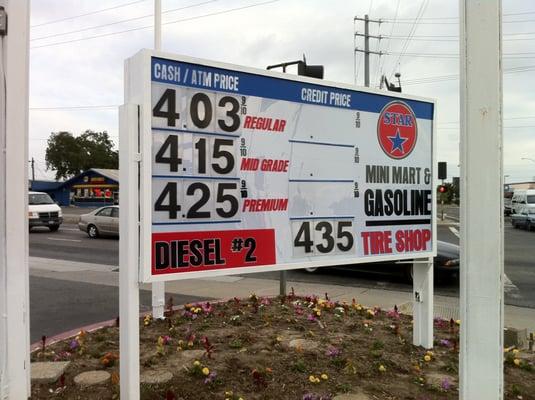 Gas station sign with interchangeable number track system on lexan face. 3 color vinyl