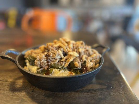 GGP. Stone ground grits topped with collard greens, pork, and fried onions.