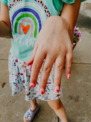 Her nails. He said he couldn't do two hearts.