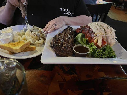 Rib eye with lobster Friday night special served with baked potato and salad with toast. Nicely done.