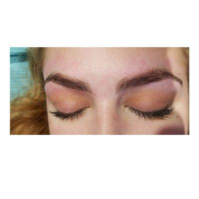 Full beautiful brows freshly shaped.