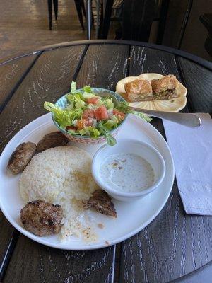 Köfte (Turkish meatballs) with rice, salad, and baklava)