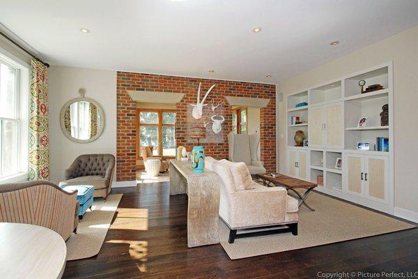 Multipurpose great room off kitchen....TV, conversation, dining all rolled into one! Custom wall unit doors slide to reveal TV.