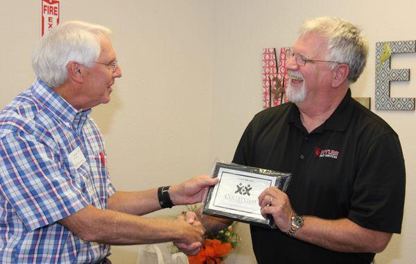 Pat Myles (owner) Receiving the Colleyville Chamber of Commerce plaque.