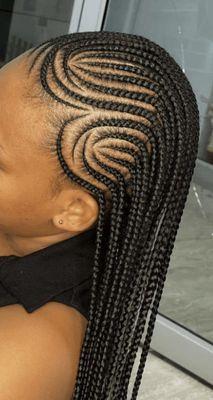 Styled conrrows called Fulani braids with half conrrows and half box braids