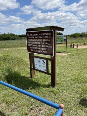 Explanation of how land was acquired. Behind the map. Behind that a scout project w a human sundial.