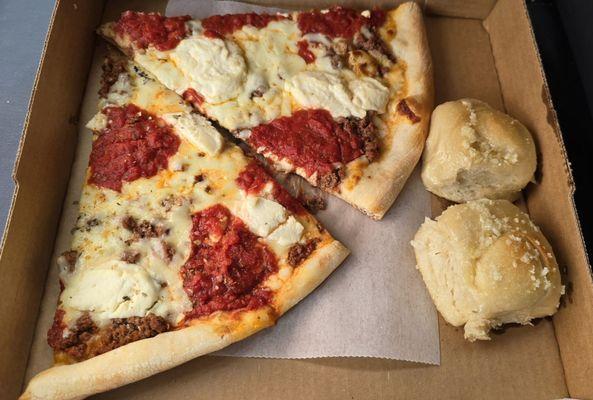 Slices of lasagna pizza with garlic knots