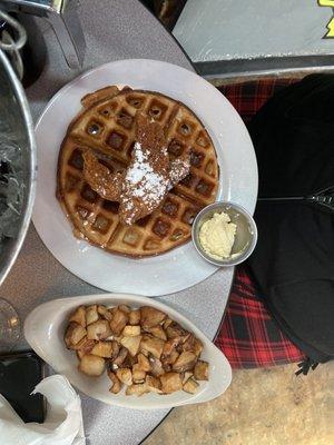 Chicken and waffles with a side of potatoes