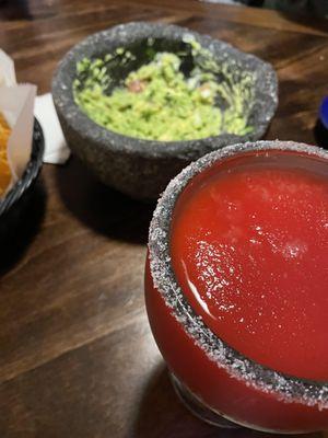 Frozen strawberry margarita and guacamole