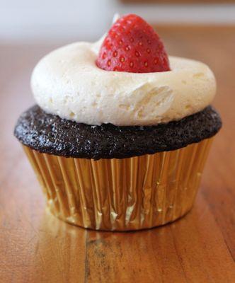 Old Fashioned moist Chocolate cupcake stuffed with Nutella & topped with smooth & creamy vanilla buttercream, garnished with a fresh berry