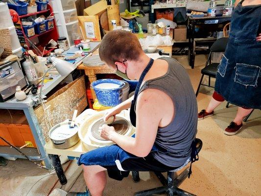 Students Learning How To "Throw" Pottery On The Wheel.