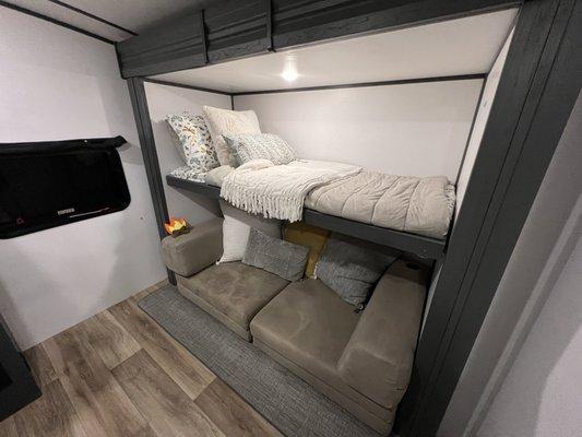 Bunk room with reversible couch lounge/ bed