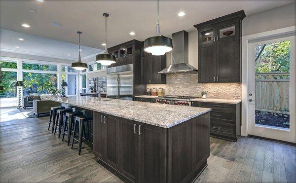 Nice Cobblestone color cabinets with designed level color countertop and backsplash.