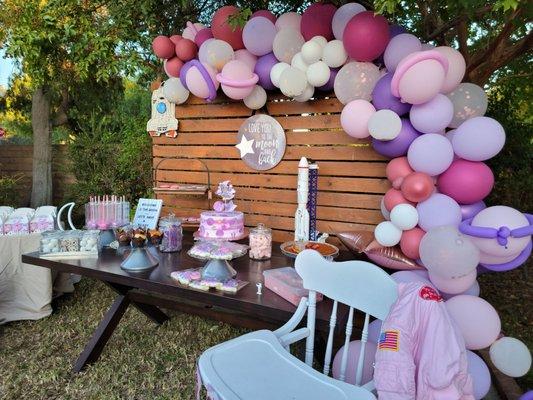 Love You To The Moon and Back sign from Amy's front and center at birthday party dessert table.