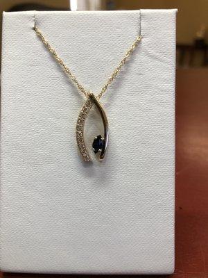 custom made 14k yellow wishbone pendant set with customer's diamonds and marquise blue sapphire.