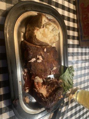 Rib and chicken combo plate with baked potato as side.