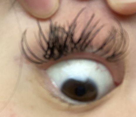 Eyelashes clumped and glued together