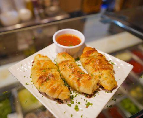 Garlic Cheese rolls with a side of sauce