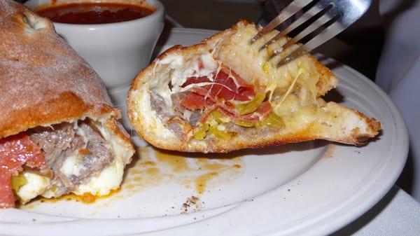 Inside of calzone (pepperoni, sausage, and hot banana peppers as toppings)