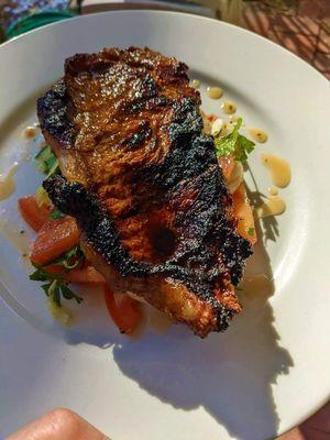 NY Strip charred over chilled cucumber, tomato, sweet onion salad, red wine vinaigrette