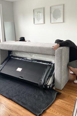 Re inserting the pull out section of the couch.