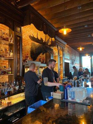 Bar top, bartender making our smoky old fashioned