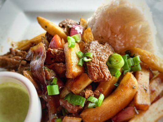 Lomo Soltado, sautéed New York steak with vegetables, rice and potatoes.