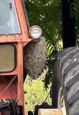 bald-faced hornets nest on side of tractor - Carmichaels PA