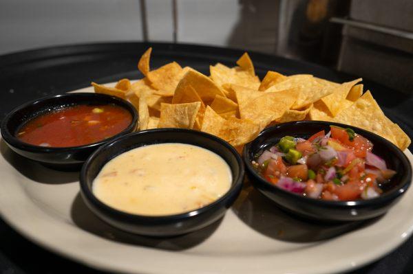 3 Dip Trio Appetizer. House cut chips served with Blanco Queso, Pico de Gallo, and fresh salsa.