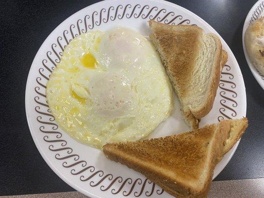 2 eggs over medium, buttered white toast,