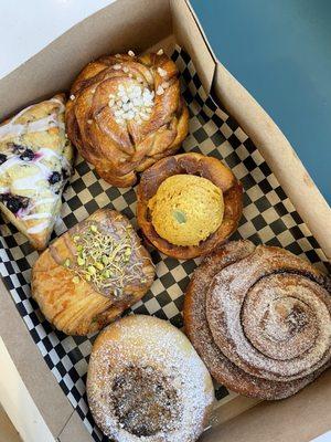 Lemon blueberry scone, apple danish, pistachio chocolate croissant, cardamom bun, pumpkin roll, lavender goat butter cookie