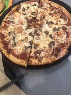 Half mushroom and half beef pizza