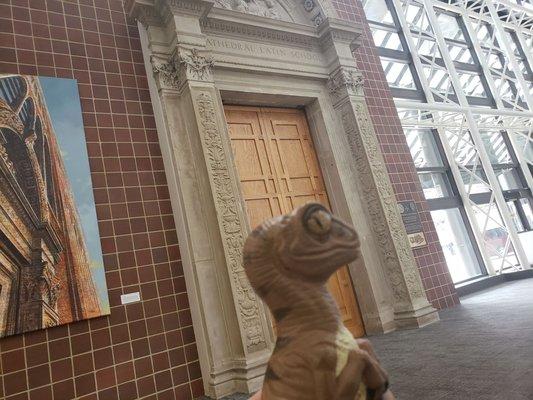 Bob the Raptor says "In the lobby there is an old archway... interesting choice mammals!"