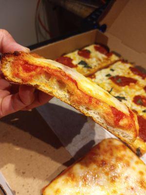 Sicilian pizza slice, side profile action