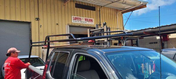 Securing the new racks to the bed of the truck.