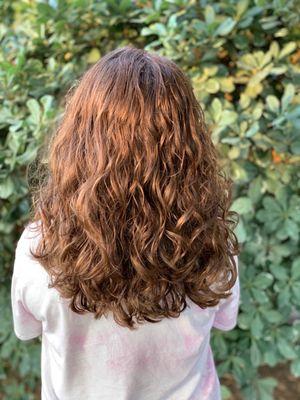 Long layers for her curly/wavy hair to help combat tangles