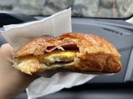 Breakfast croissant with eggs/ham/bacon/cheese. It was freshly toasted, delicious, and flaky!