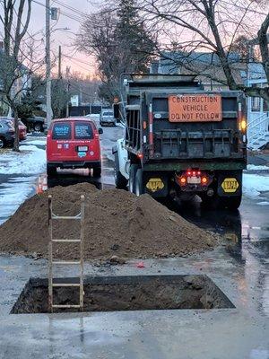 Main line drain / sewer backing up. Line was broken in the street we performed emergency Excavation to repair.