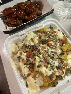 Nachos with steak and chicken wings with Taco Libre sauce