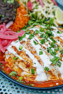 Stacked Enchilada: Brisket on flour torts with pickled onions, lime crema, Jack cheese, and cotija. Comes with rice and beans!