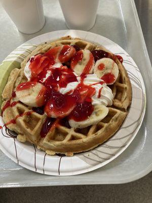 Belgian waffle with fresh strawberries and bananas and whipped cream in their cafeteria like 395