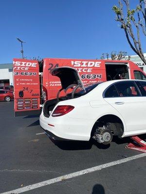 Car tire being repaired by GI Services