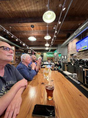 Watching KU basketball with friends at the bar counter.