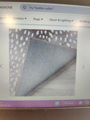 Website photo shows edging and back of rug