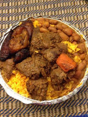 Beef stew with yellow rice, stewed red beans and Maduros